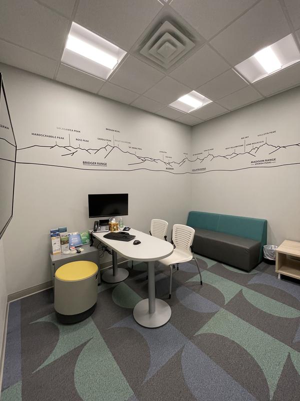Consultation room with seating and a wall mural