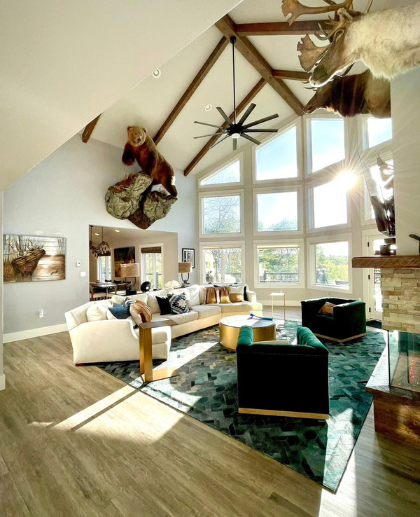 Vaulted great room with exposed beams and a stone fireplace