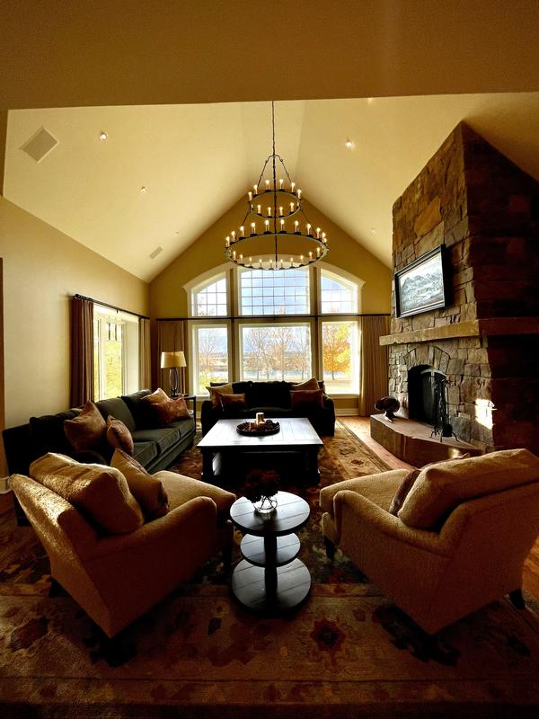 Living room with a stone fireplace, guest-ready
