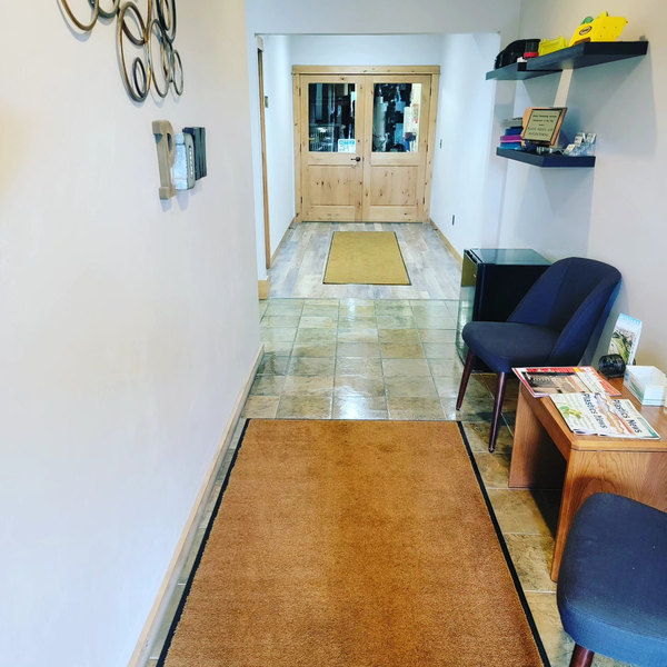 Reception hallway at a manufacturing facility with fresh tile and matting
